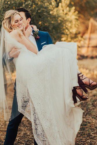 couple poses bride in the groom arms tessatadlock