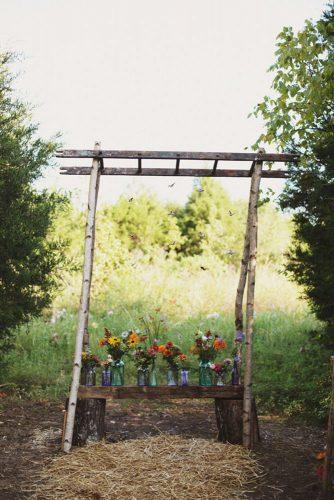 hippie wedding diy altar with colorful glass bottles and flowers ulmer studios