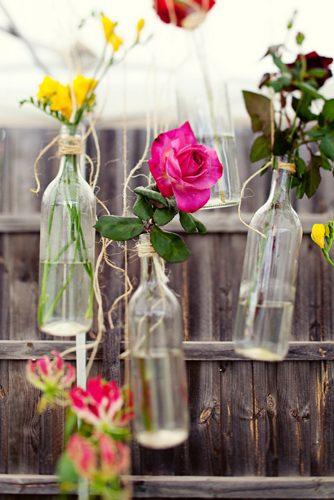hippie wedding suspended bright flowers in glass bottle jonathan ong photography