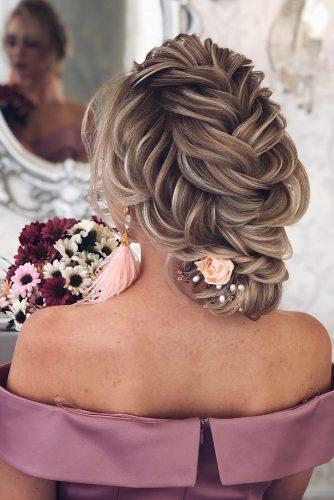 hottest bridesmaids hairstyles ideas low updo with french braids decorated with pink flowers babaevski