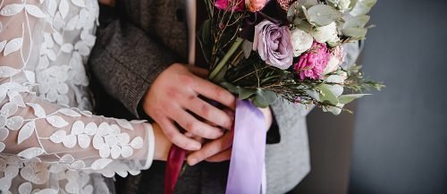 simple wedding ideas newlyweds with bouquet featured