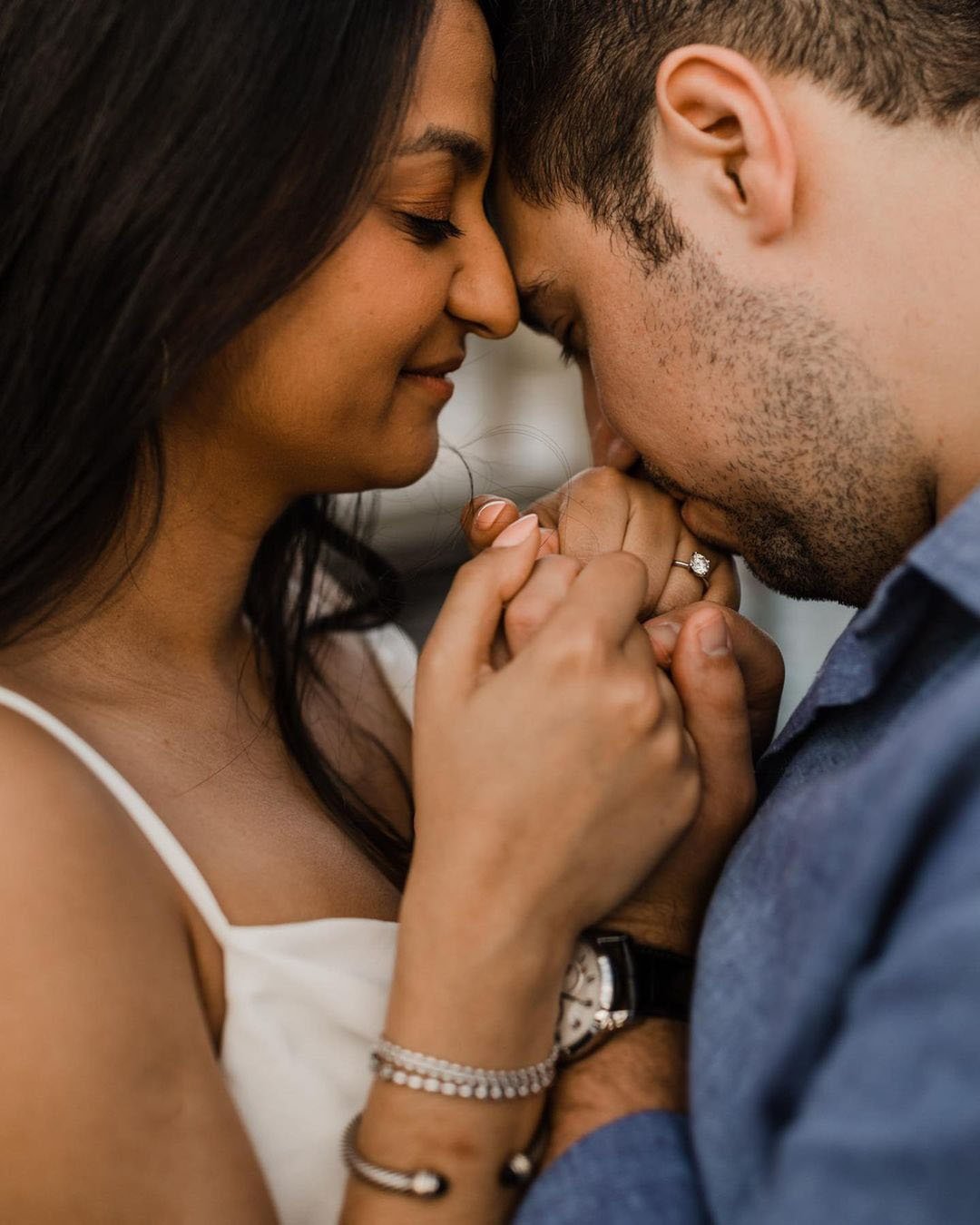 engagement announcements photo man kissing womans hand