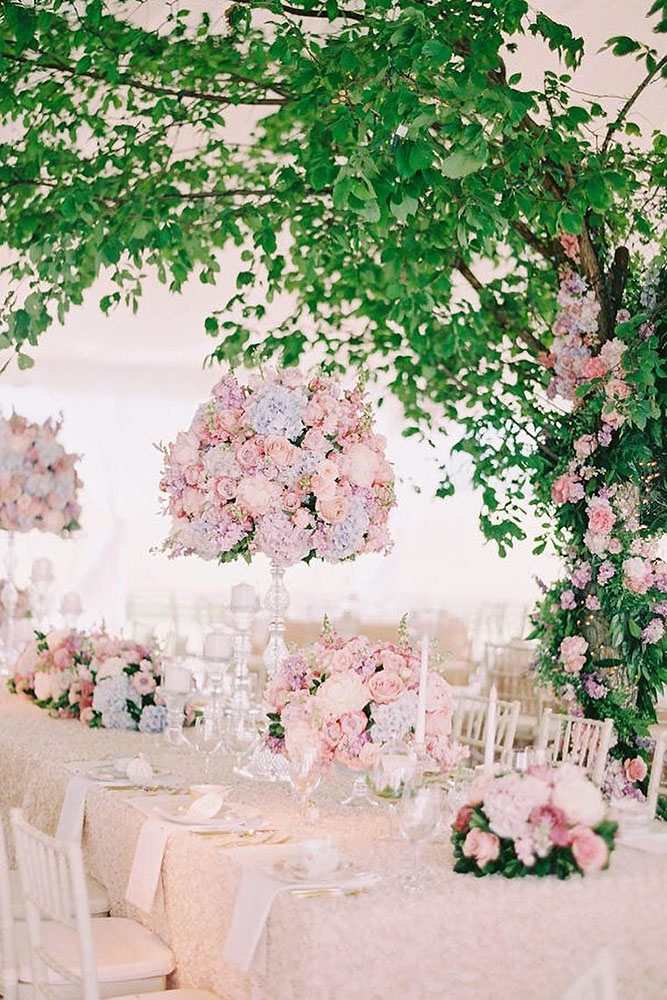 tall wedding centerpieces on a thin stand soft delicate lilac and pink flowers of pastel tones katie stoops via instagram