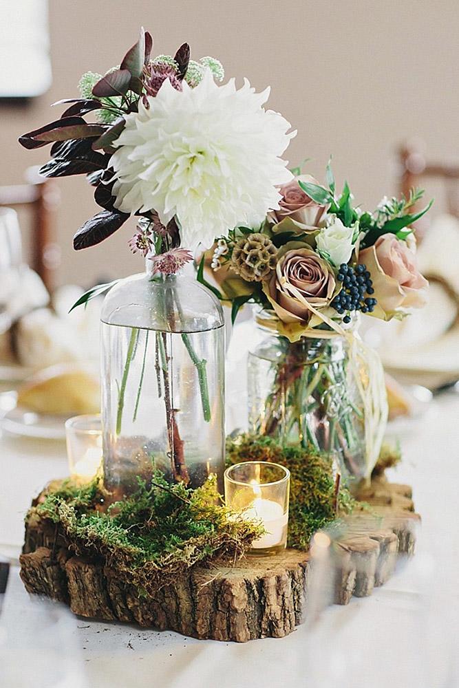 ustic wedding centerpieces in glass bottles moss and candles around clean plate pictures
