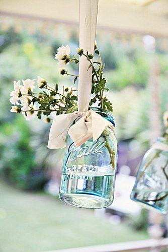 mason jars wedding centerpieces blue glass suspended with flowers abeachcottage via instagram