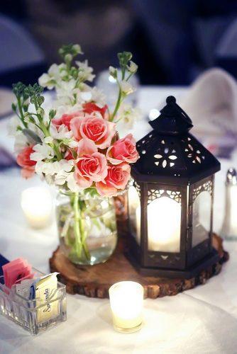 rustic wedding lanterns with a mason jar candle with pink roses on a wooden slice blue martini photography