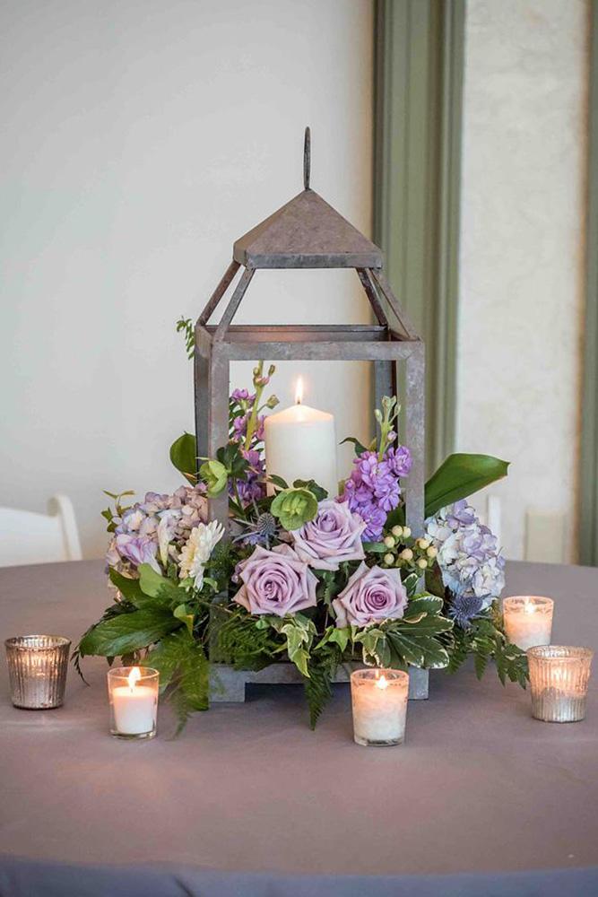rustic wedding lanterns with candles surrounded by lilac roses allure wedding photography