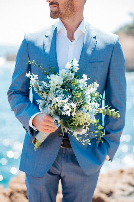 blue wedding theme blue groom suit groom with flower