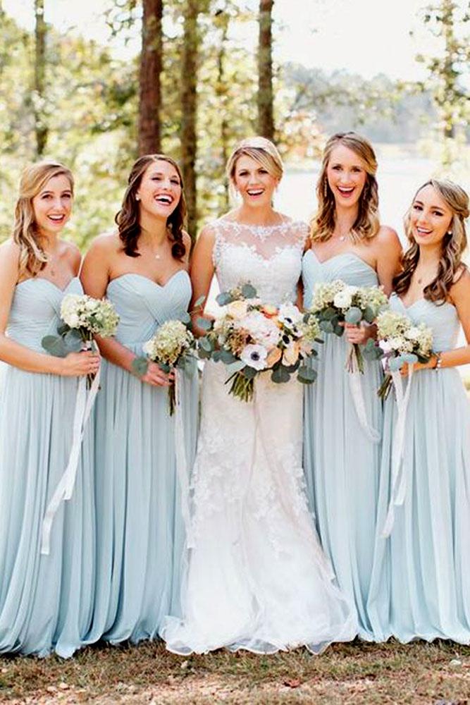blue wedding theme bride and bridesmaids in blue dresses in forest