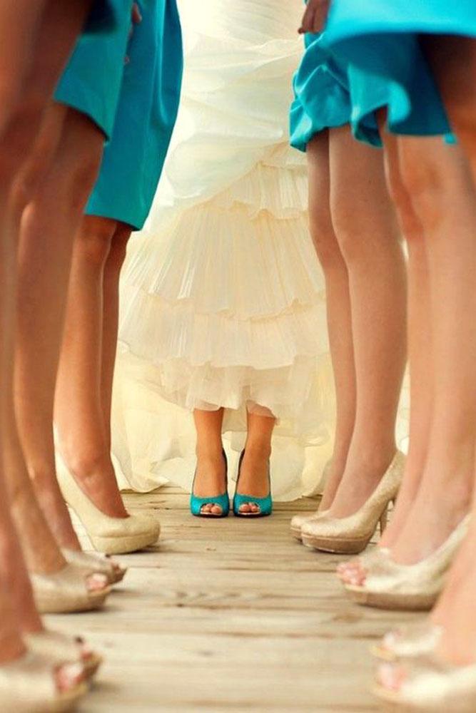 blue wedding theme bride in blue shoes with bridesmaid in gold shoes