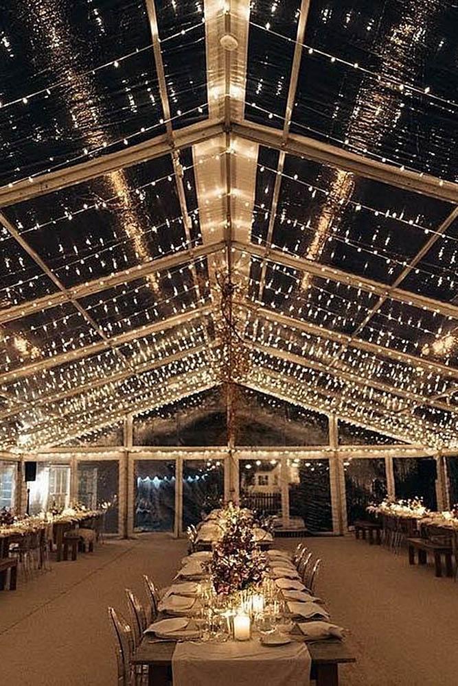 wedding tent transparent with light bulbs on the tables candles flowers losberger us via instagram