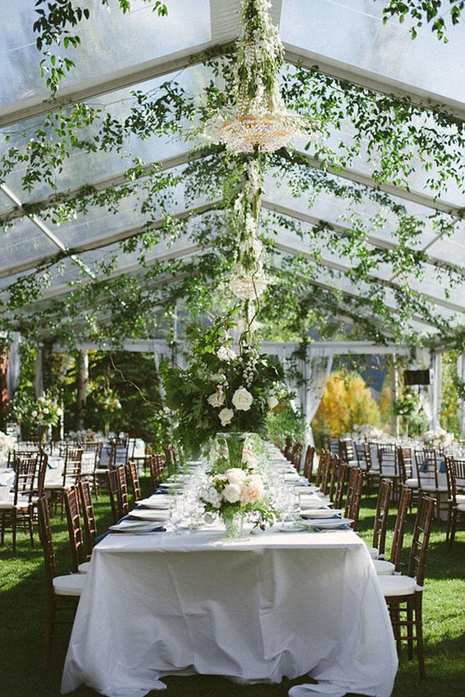wedding tent white tablecloth chairs decorated with greens hite roses losberger us via instagram