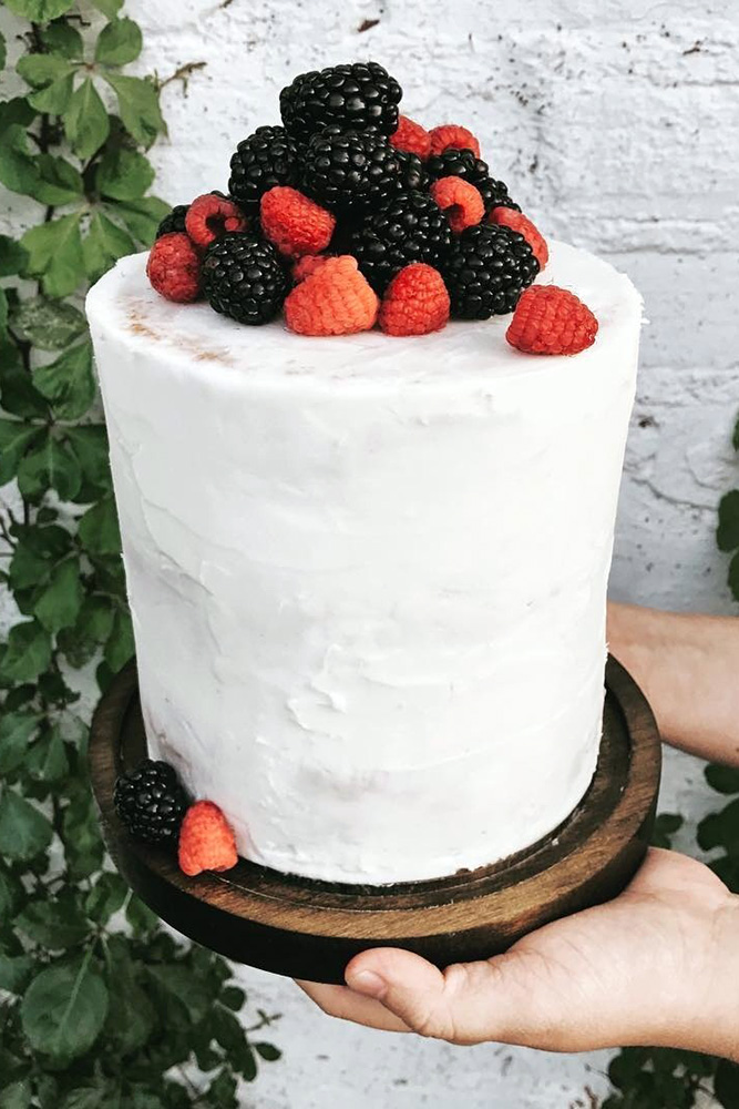 italian wedding cakes cream with berries of raspberry and mulberry on a wooden stand katlyn gruber via instagram