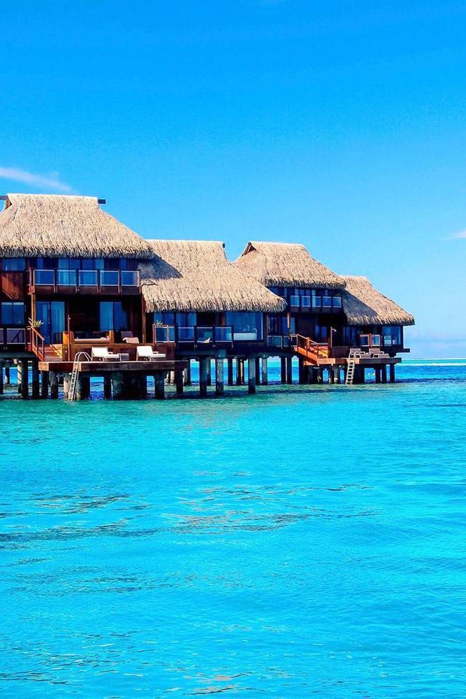 tropical honeymoon destinations bora bora villas on a blue sea jetsetchristina via instagram