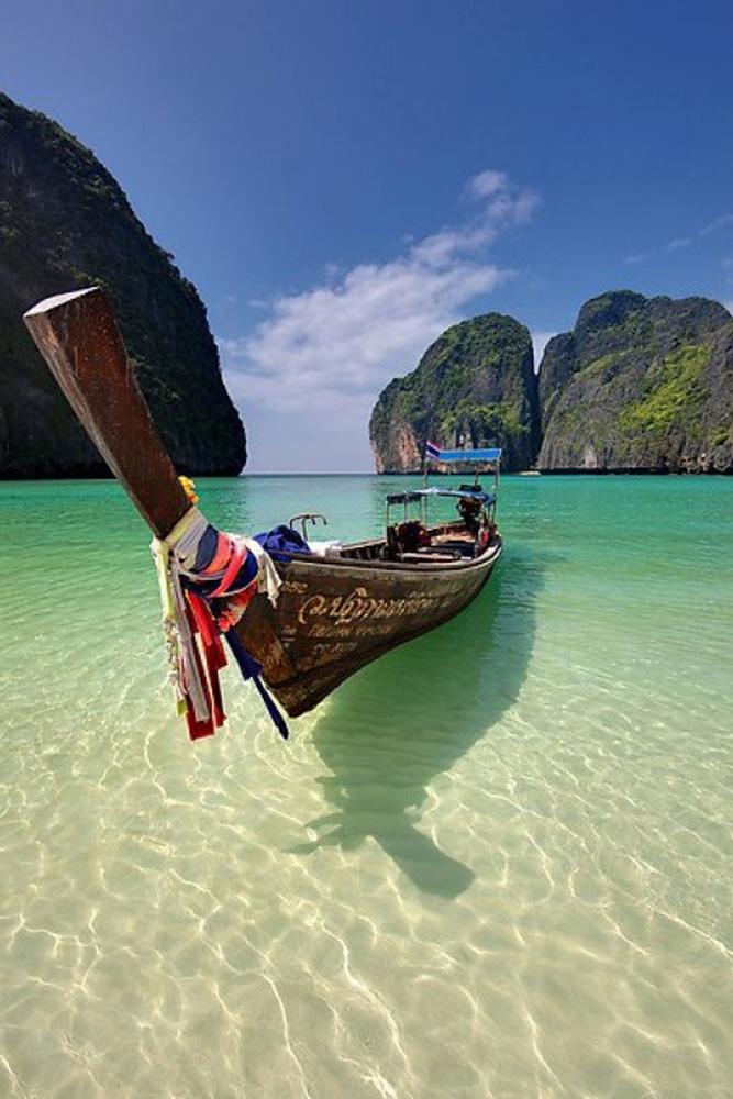 tropical honeymoon destinations thailand a boat at the sea exploring light photography