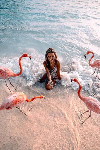 affordable honeymoon packages aruba girl girl feeding pink flamingos at the beach