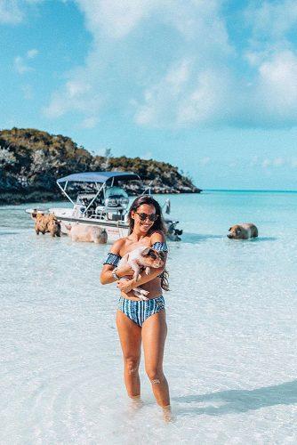 affordable honeymoon packages bahamas girl at the beach with cute pig