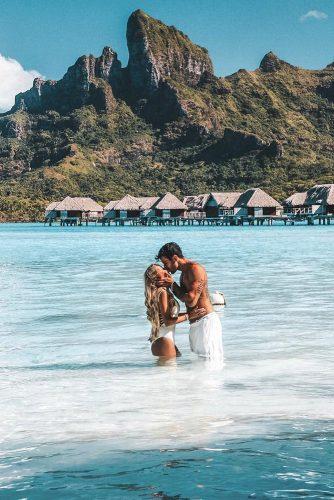 affordable honeymoon packages bora bora man and woman kissing at the water