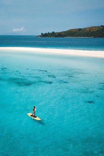 affordable honeymoon packages cook islands man on the serf board