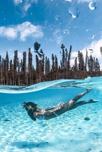 affordable honeymoon packages new caledonia clear water woman swimming