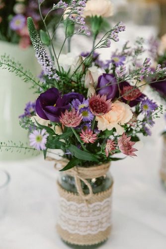 rustic wedding décor in the bank decorated with lace wildflowers and roses decorate the table natalie j watts via instagram