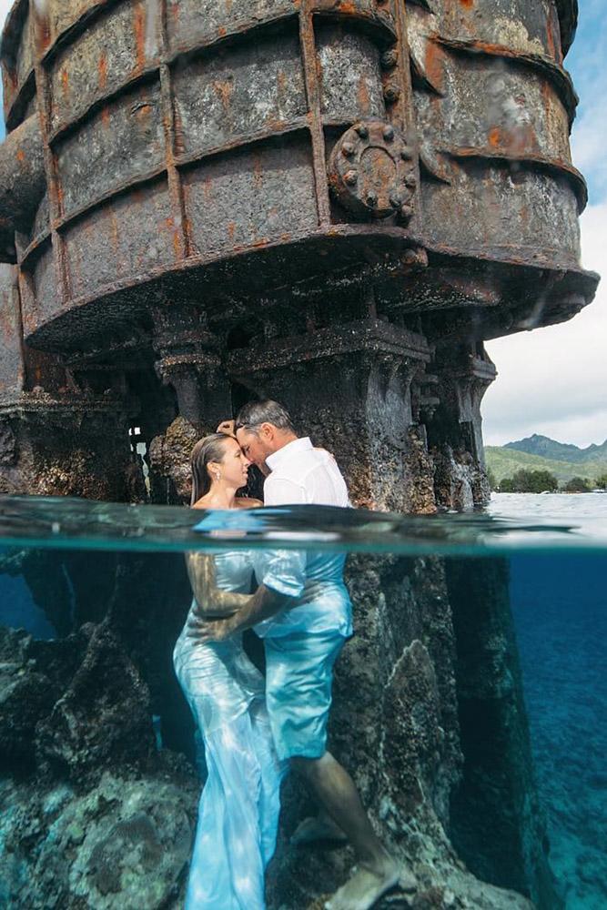 tropical honeymoon destinations cook islands bride and groom in water turama photography