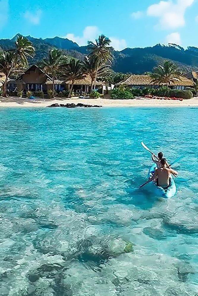 tropical honeymoon destinations cook islands bride and groom swim in a boat brennadillon via instagram