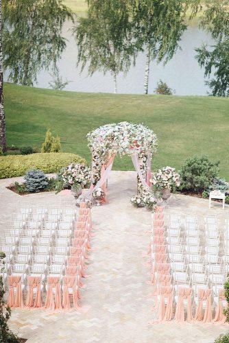 wedding ceremony decorations aisle and wedding altar with pink cloth and flowers sonya khegay