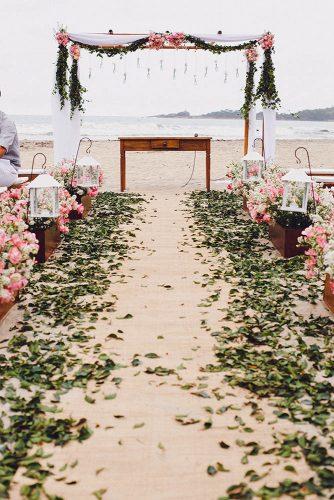 wedding ceremony decorations romantic ceremony woth blush flowers and greenery on the beach rafael canuto fotografia