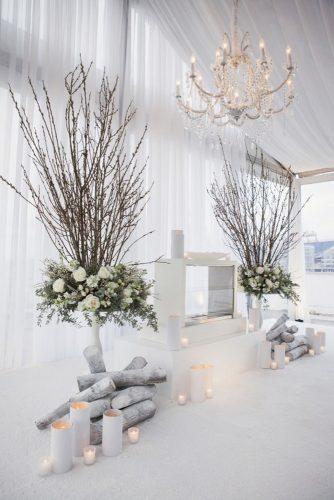 wedding ceremony decorations winter decor with branches white roses and candles sage nines event production