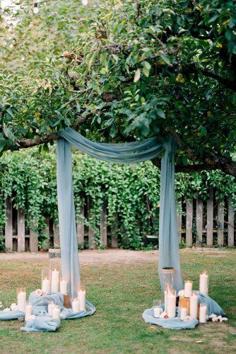 wedding ceremony decorations with blue draping cloth and candles dennis roy coronel