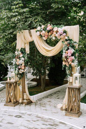 wedding ceremony decorations with peach cloth draping and roses anishenkowithlove