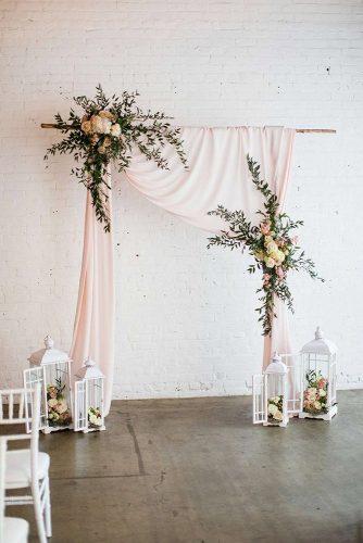 wedding ceremony decorations with pink draping cloth and flowers with greenery blossom farm vintage rentals