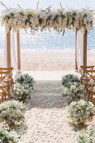 wedding ceremony decorations with white orchids and cloth on the beach iamflower via instagram