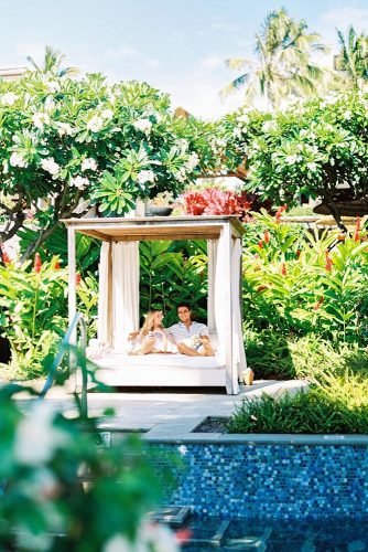 hawaii honeymoon couple on a lounger in the courtyard among the green agoodwin1