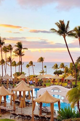 hawaii honeymoon swimming pool and tall palm trees by the sea in the courtyard of the hotel asideofsweet