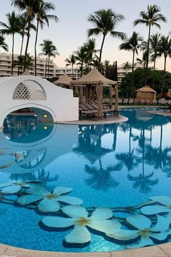 hawaii honeymoon swimming pool with a white mosquito and white tropical flowers at the bottom lukeness17