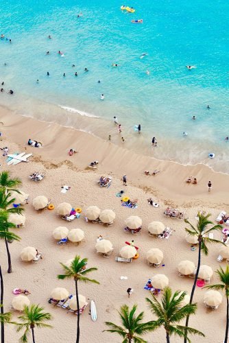 hawaii honeymoon view from the hotel window to the beach with yellow umbrellas thealohaskyline