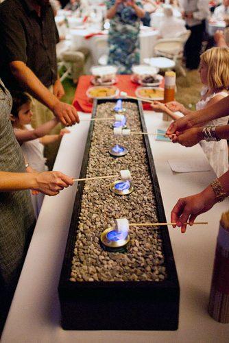 rustic barbecue bbq wedding guests roast marshmallows at the reception jesse rashotte photography
