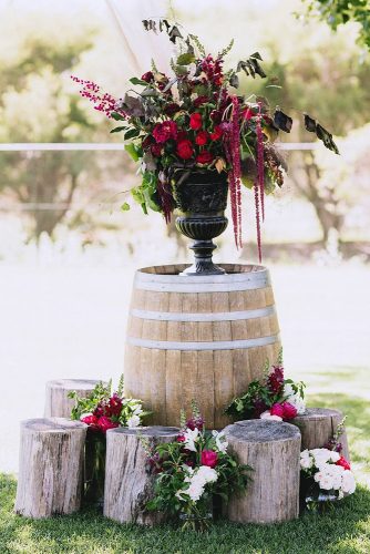 wine barrels wedding decoration with a wine barrel and red flowers in a black vase perth wedding