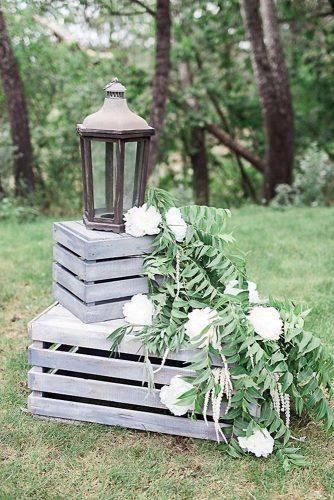 wooden crates wedding decoration with white flowers and greenery rustic lantern amber tyler photography