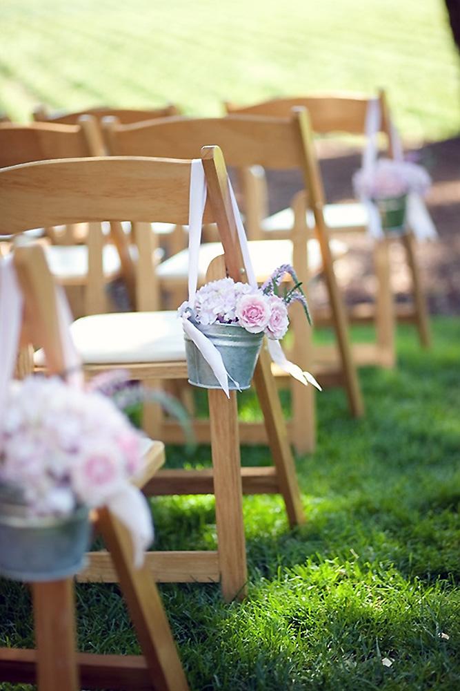 country wedding buckets with pink roses and ribbons decorated the aisle julie mikos photography