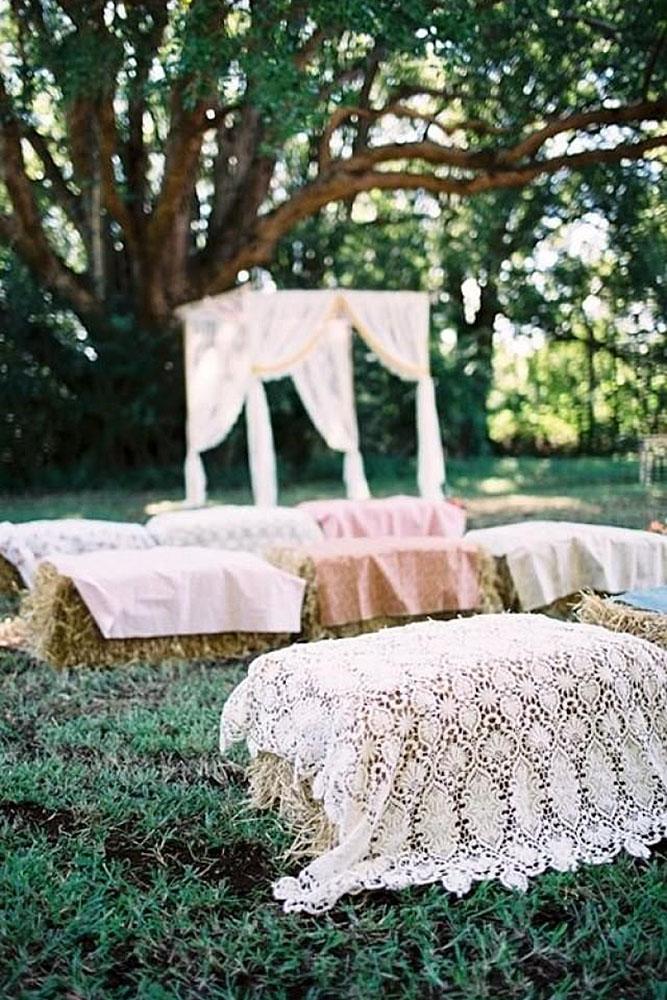 country wedding ceremony vintage lace and hay bales seatings feather and stone