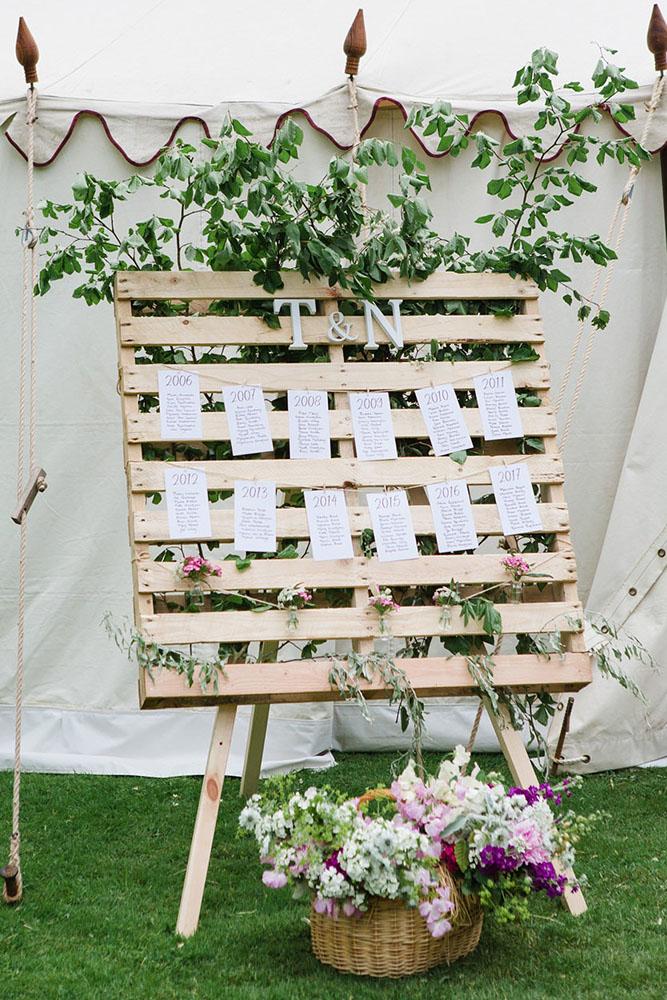 country wedding pallet stand decorated with breenery and flowers lucy_davenport via instagram