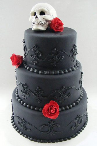 halloween wedding ideas black cake decorated with patterns and red roses on top of the skull weddingsbybittersweets