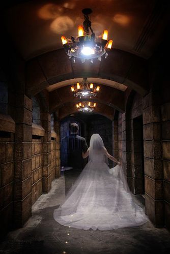 halloween wedding ideas groom and bride ghosts walk along the stone corridor disney fine art photography & video