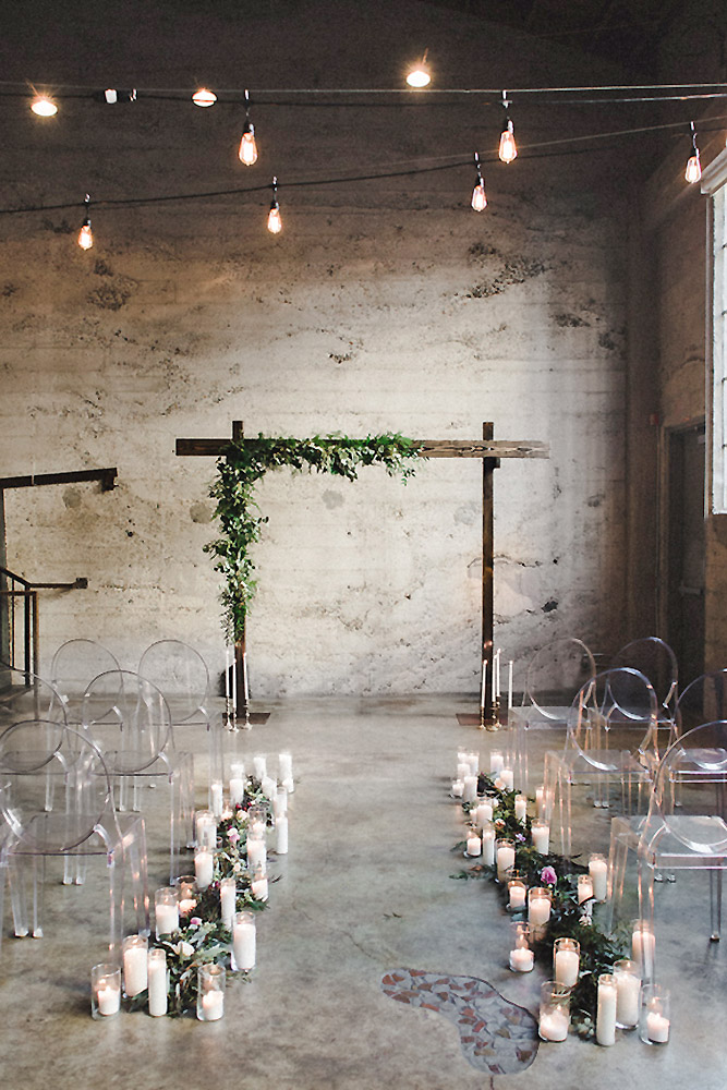 loft decorating ideas in the industrial style wooden arch with greenery meghan elise photography