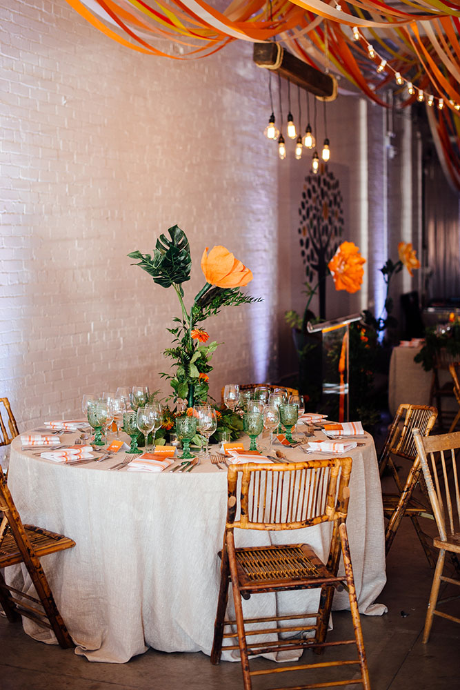 loft decorating ideas reception with bright colors tables and light bulbs sara monika via instagram