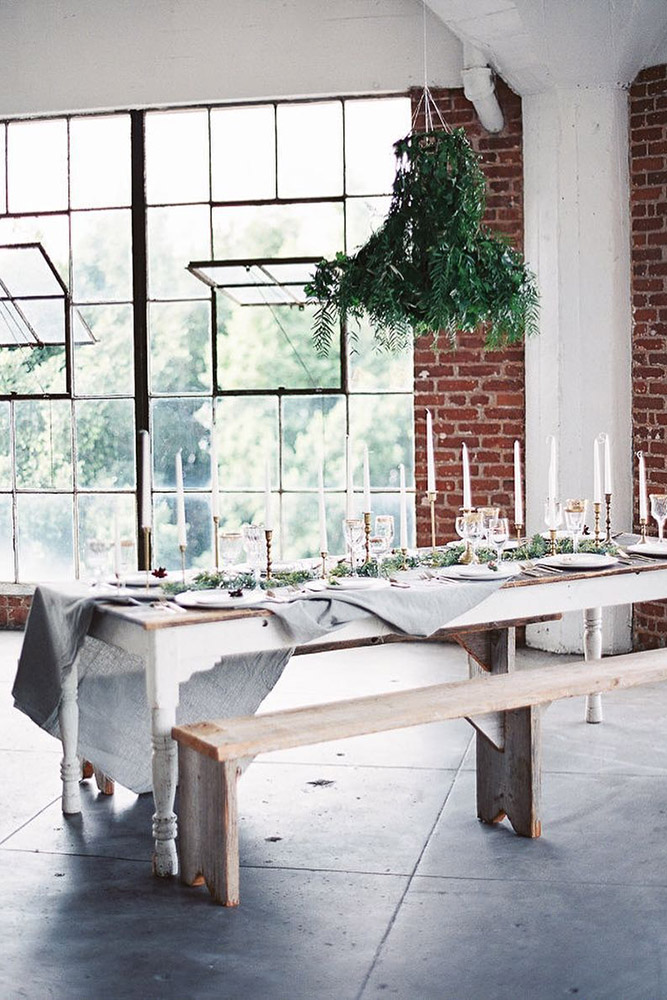 loft decorating ideas wooden table with candles and greenery benches wedding photographer via inst