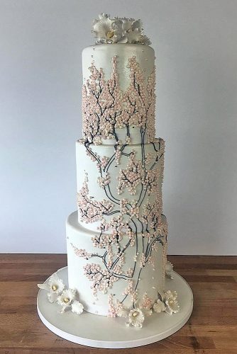 unique wedding cakes tall white with branches and pink mother of pearl charm city cakes via instagram